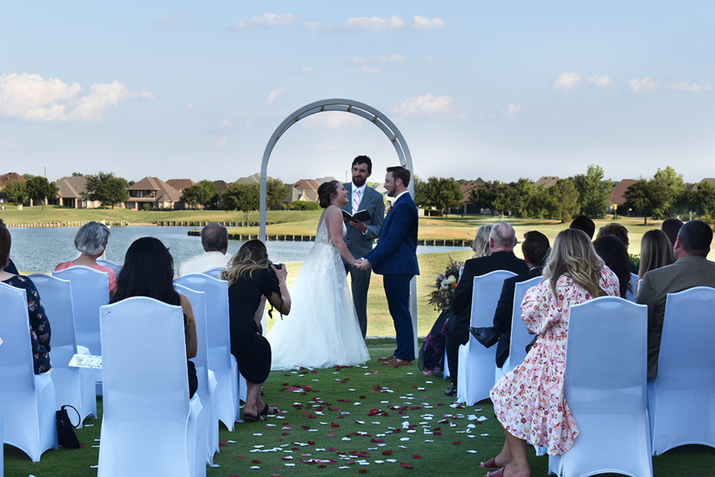 Bride and groom at wedding ceremony on golf course